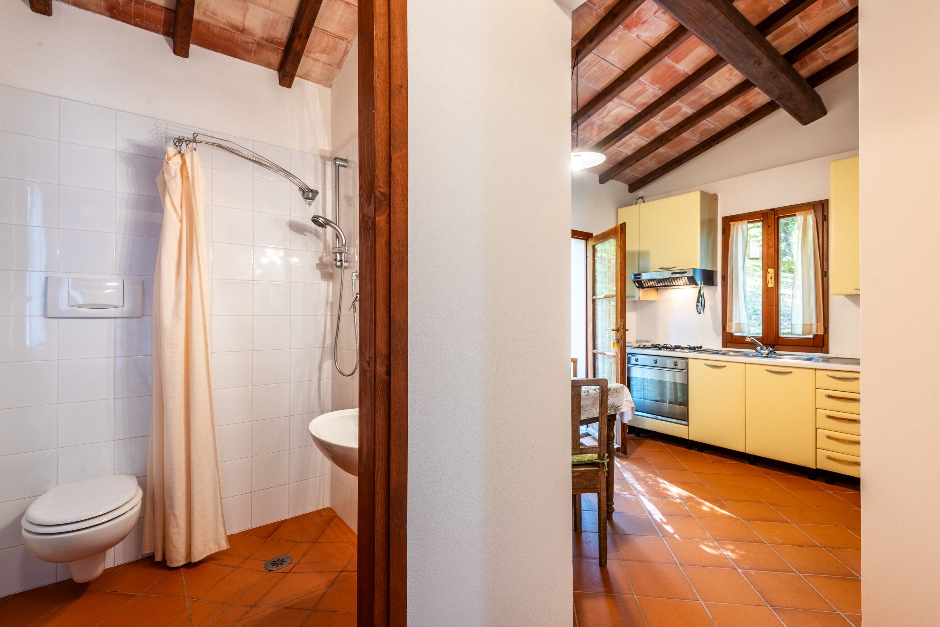 A bathroom with a shower, toilet, and a sink.