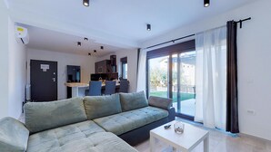 A modern living room with a sectional sofa, a dining area, and a kitchen. - Stunning apartment in Drenje with WiFi (Drenje)