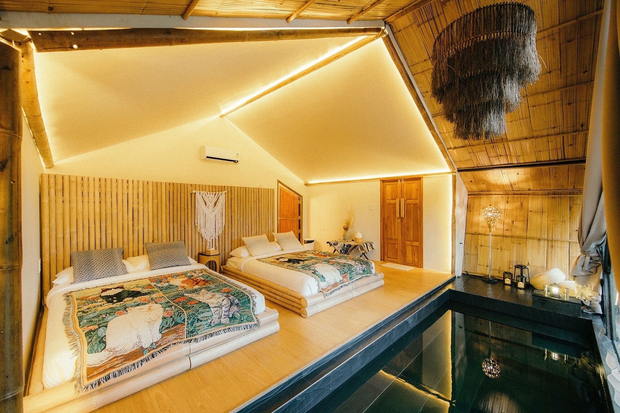 A room with two beds, a wooden ceiling, and a glass partition.