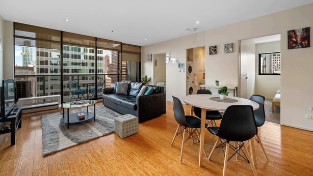 Een modern appartement met een zithoek, eethoek en een wasruimte.