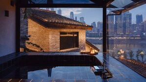 A modern building with a view of a city skyline and a river. - Futon Designer Hotel (Liberation Monument&Nanbin Road Store) (Chongqing)