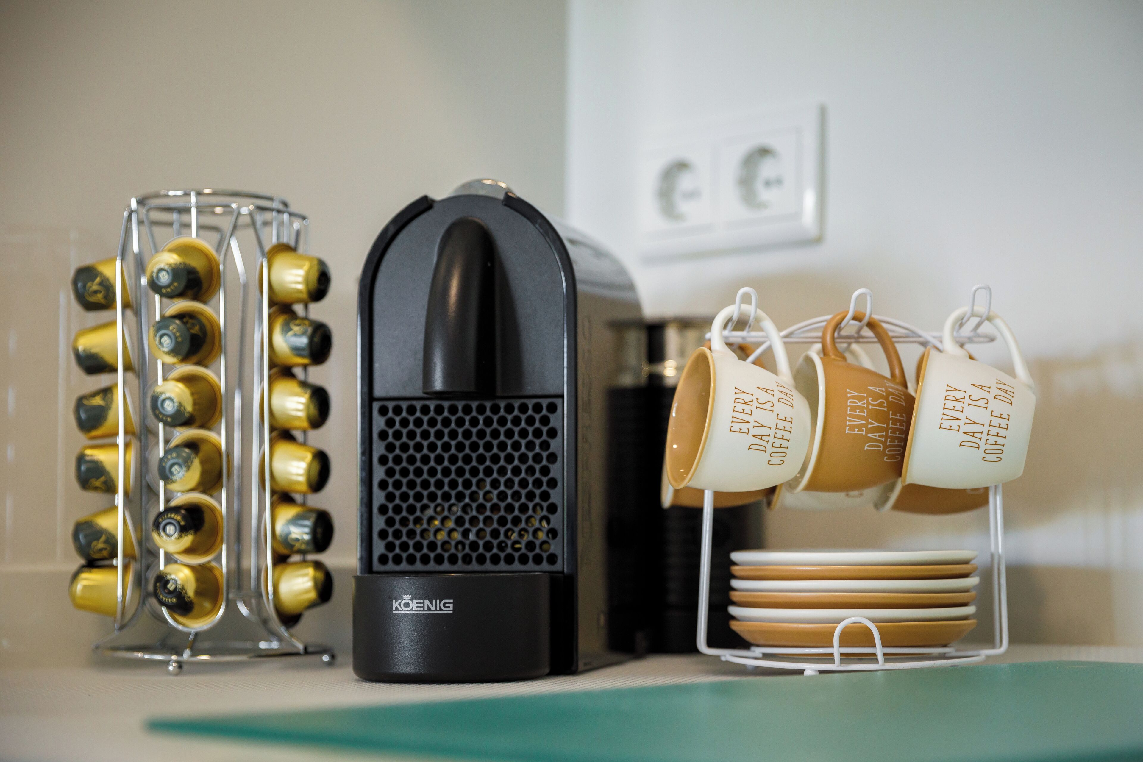 Una cafetera, un portabotellas de vino y un soporte para tazas de café.