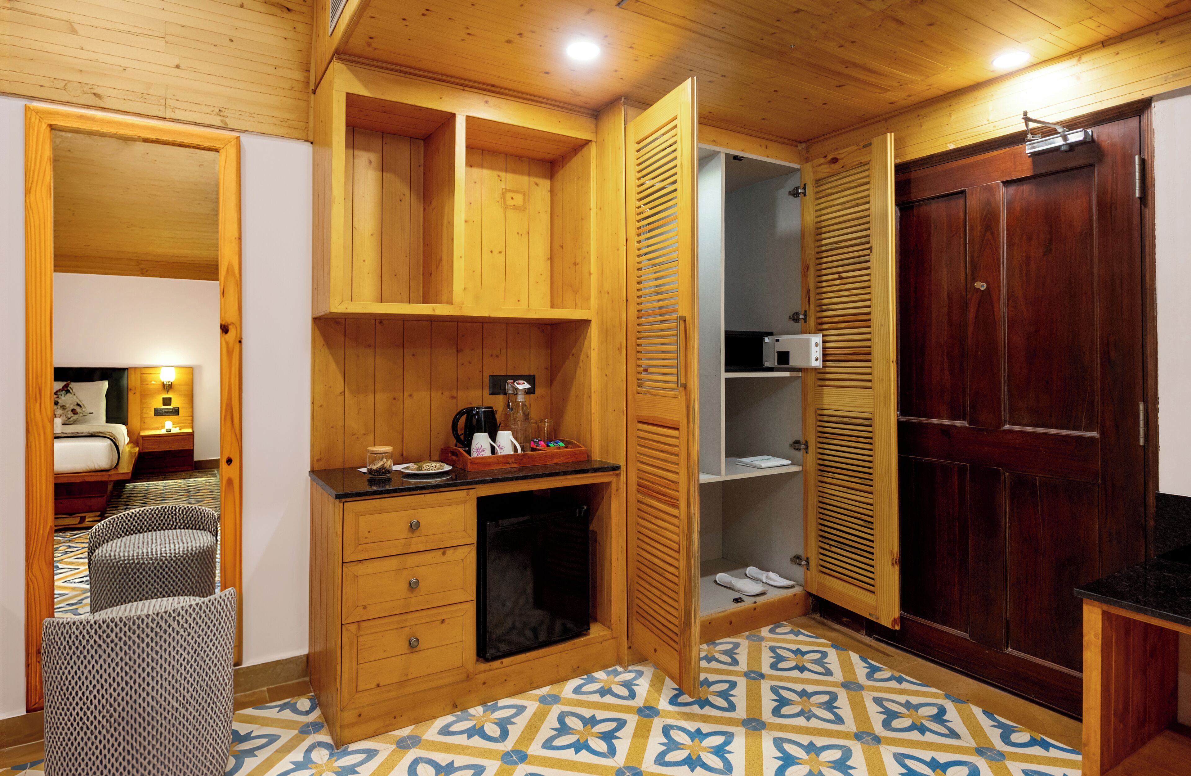 A compact kitchen with wooden cabinets, a microwave, and a small countertop.