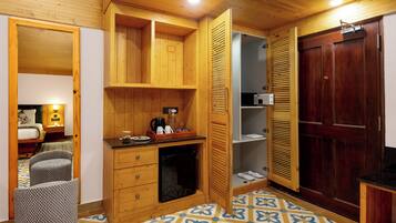 A compact kitchen with wooden cabinets, a microwave, and a small countertop.