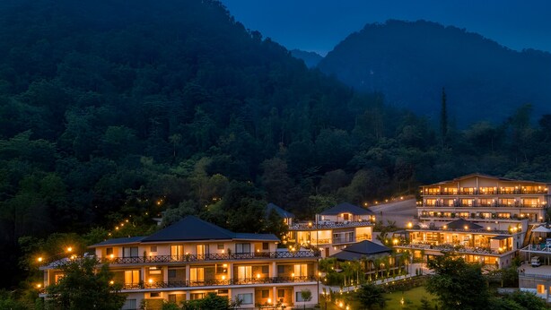 A multi-story hotel with a modern design, featuring balconies and large windows. - The Orchid Rishivan Rishikesh (Rishikesh)
