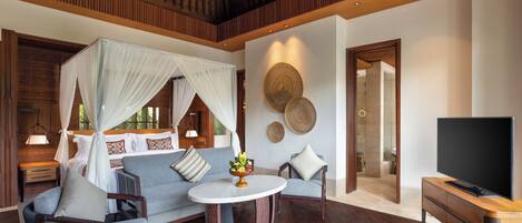 Una habitación moderna con una cama, un sofá, un televisor y una mesa de centro.
