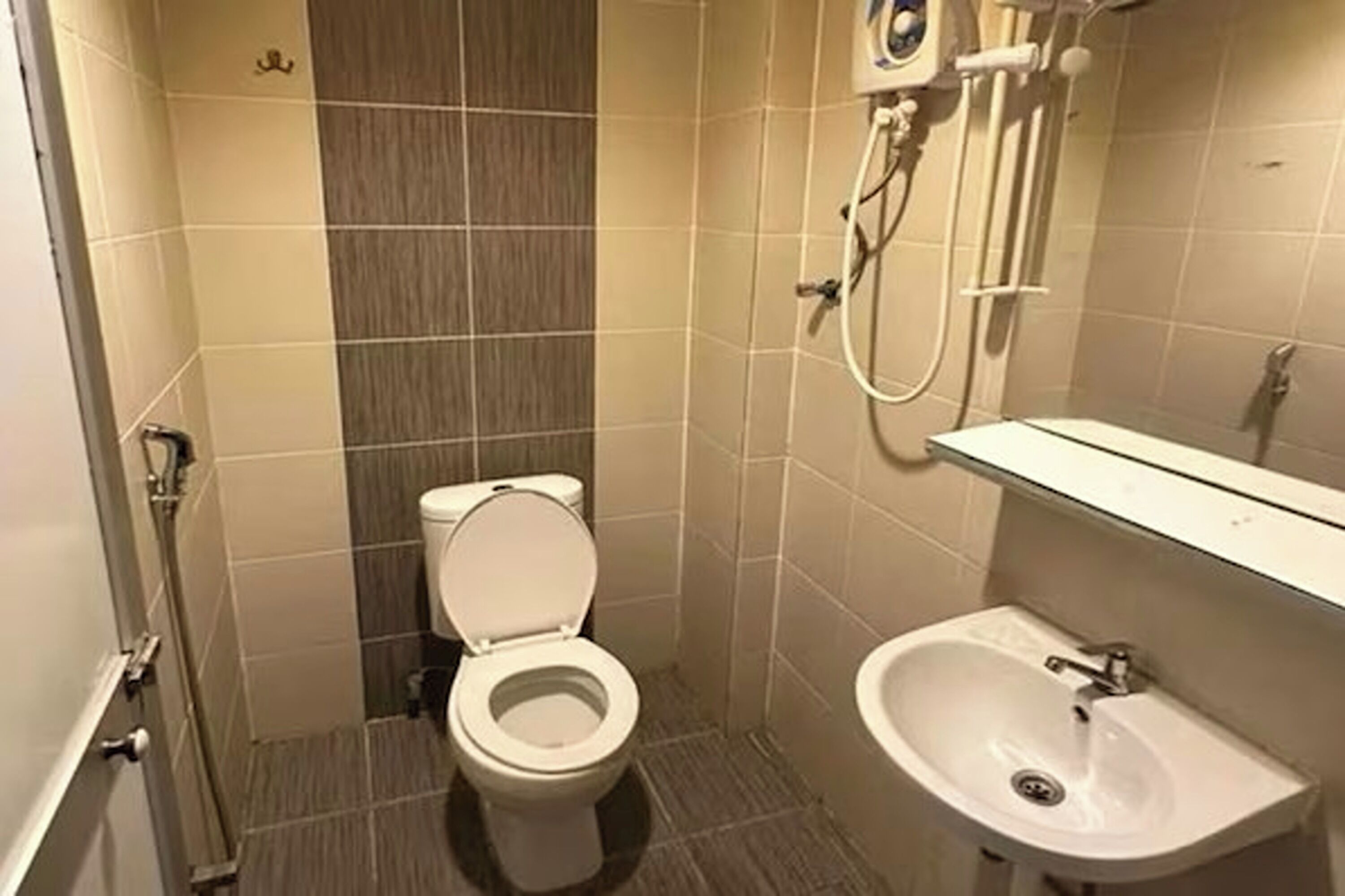 Ein kleines Badezimmer mit Toilette, Waschbecken und Dusche.