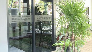 A hotel entrance with glass doors and a sign reading "HOTEL WUALAI." - Hotel Wualai By Cmstay (Chiang Mai)