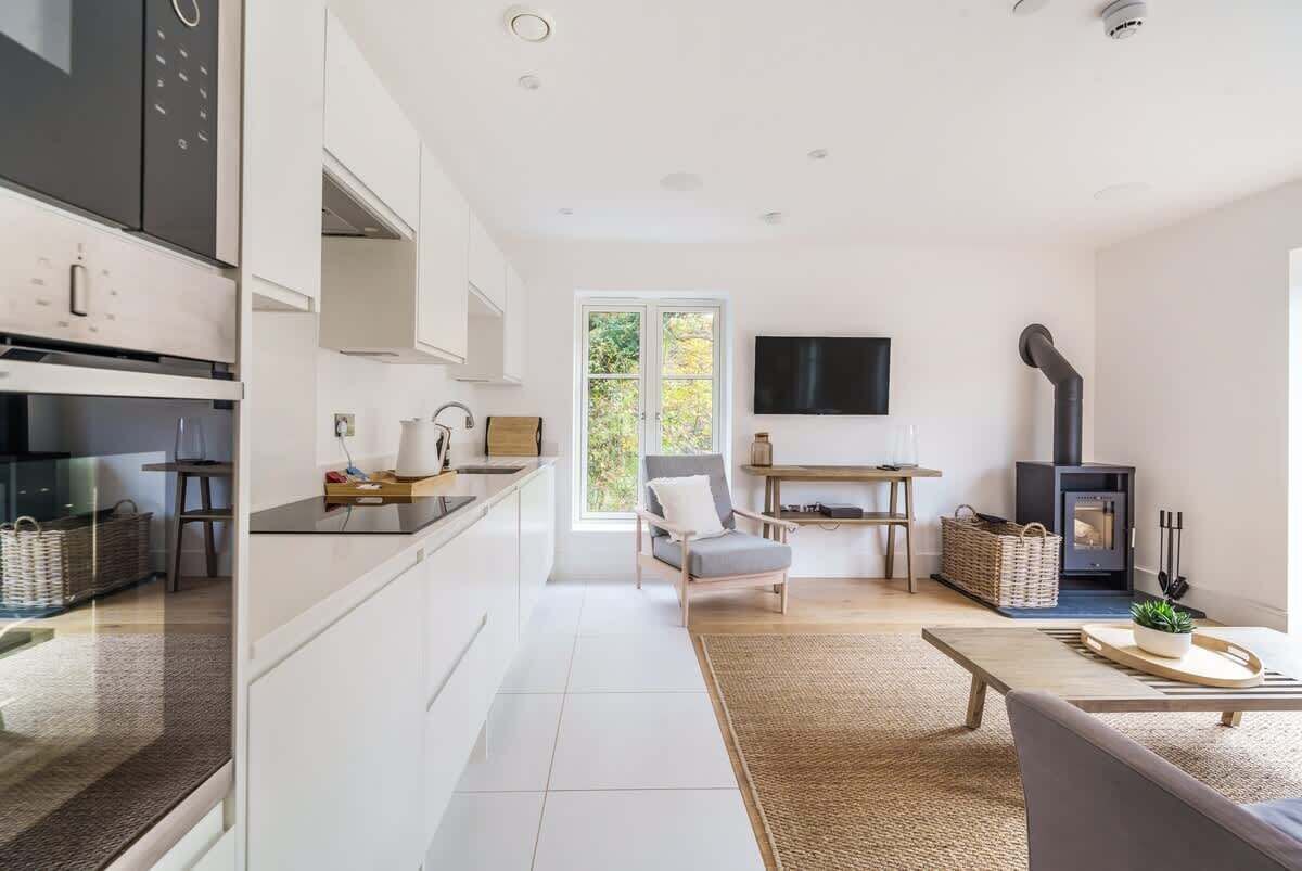 Experience the expansive elegance of our open-plan living room, which is built for comfort and easy relaxation in the centre of your stay.