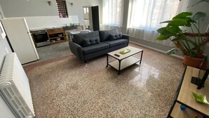 A living room with a sofa, coffee table, and a potted plant. - Self-contained apartment in village house (Saint-André-de-Sangonis)