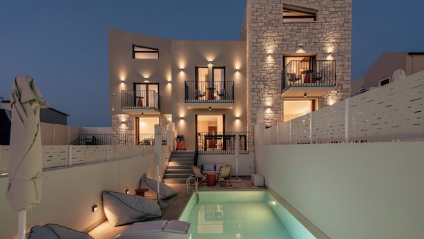 A modern two-story building with a swimming pool, outdoor seating, and a staircase leading to the upper floor. - Villa Carob, Aesthete Villas (Rethymno)