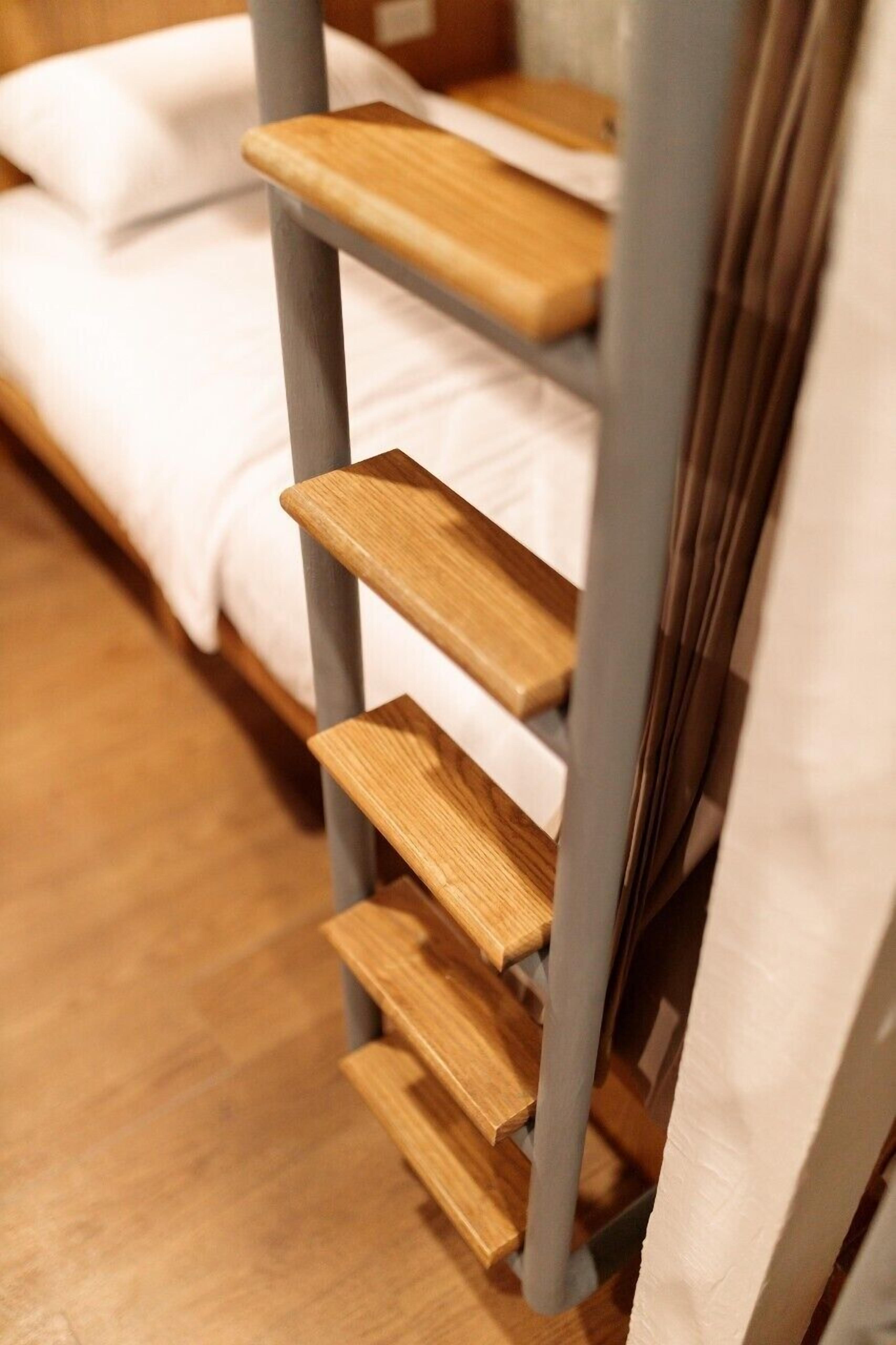 A bunk bed with wooden slats and a grey metal frame.