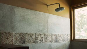A shower area with patterned tiles, a showerhead, and a window. - w Remarkable 1BR w Pool in M Ncora (Máncora)