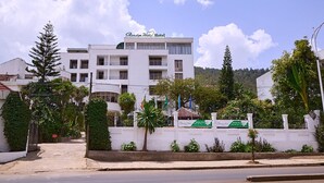 A white building with balconies and a sign reading "Garden Hill Hotel". - Garden Hills Hotel (Addis Ababa)