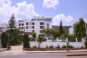 A white building with balconies and a sign reading "Garden Hill Hotel". - Garden Hills Hotel (Addis Ababa)