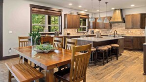 Una cocina moderna con armarios de madera, una isla central e iluminación colgante.