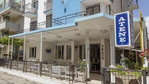 A multi-story hotel with a prominent blue sign reading "ATENE". - albergo Atene (Riccione)
