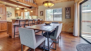 A spacious kitchen with wooden cabinets, a large island, and pendant lighting. - Live Like a Local in Truckee: Luxe Cabin Near Dtwn (Truckee)