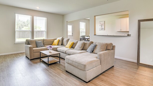 A spacious living room with a beige sectional sofa, a coffee table, and a dining area in the background. - 4 Mi to Bear Creek Pioneers Park: NW Houston Home (Houston)