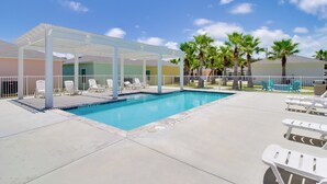 A swimming pool with lounge chairs and a covered seating area. - Fish & Swim On-site: Resort Retreat in Rockport! (Rockport)