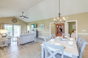 A spacious living room with a dining area, a kitchen, and a bedroom. - Golf Course View, Pool Access: Myrtle Beach Condo! (Myrtle Beach)