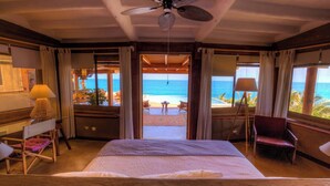 A hotel room with a bed, a desk, a chair, a lamp, and a view of the ocean. - w Enjoyable 4BR w Pool in M Ncora (Máncora)