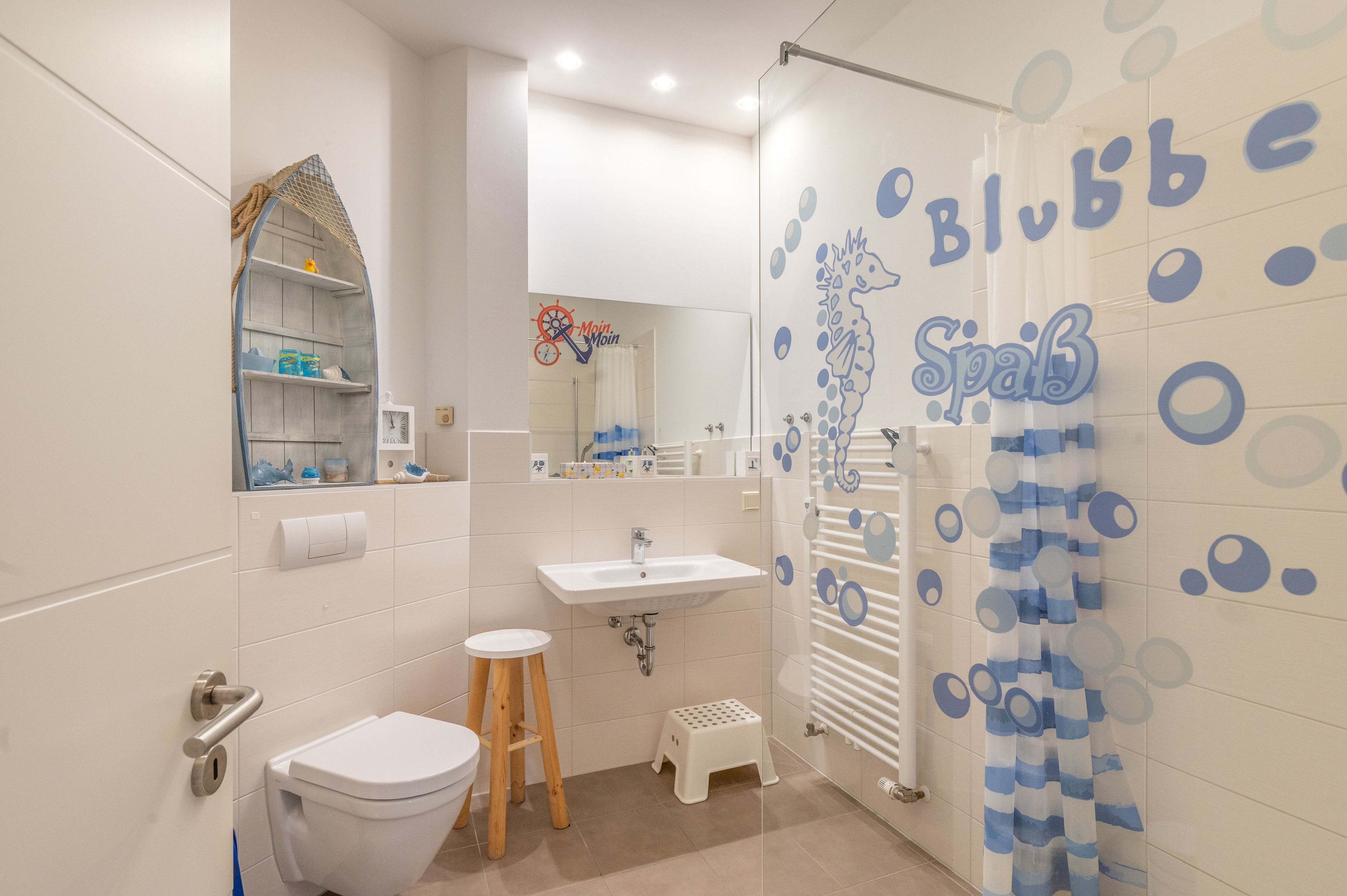 Un bagno con il WC, un lavandino e uno spazio doccia.