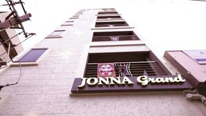 En byggnad med en skylt där det står ”JONNA Grand”.