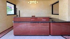 A reception desk with a marble top, a chandelier, and a window with a view of greenery. - The Four Stories - Luxury Near The Lake (Udaipur)