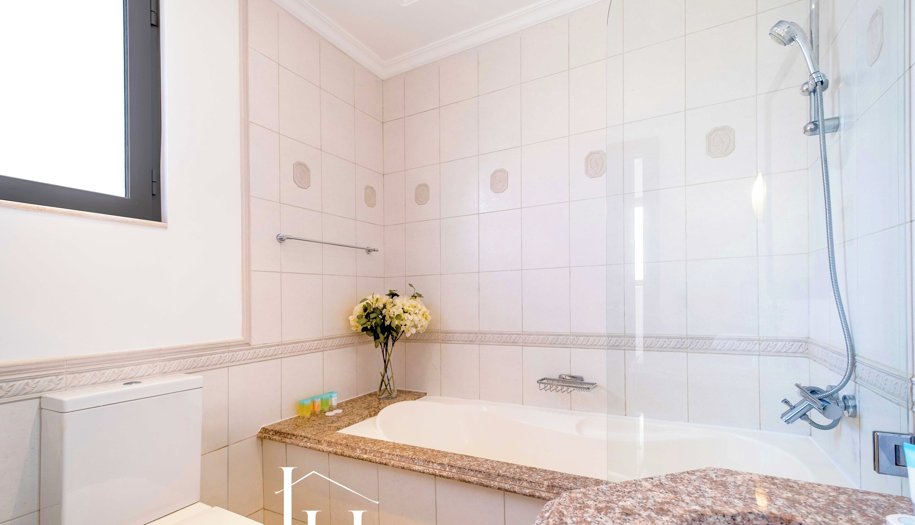 A bathroom with a toilet, a sink, a bathtub, and a shower.
