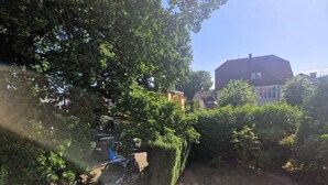 A residential area with a house, a car, and a garden.