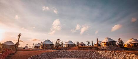 A series of yurts in a desert setting with a clear sky.