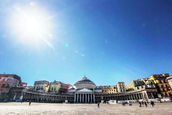 A large open square with a prominent building featuring a dome and columns. - - Domus Lux - (Napoli)