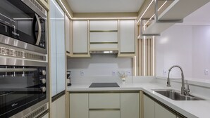 A modern kitchen with built-in appliances, a stainless steel sink, and light-colored cabinetry. - House With Pool and Barbecue Ekd0397 (Picarras)