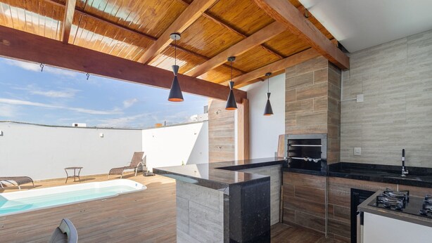 A modern kitchen with a built-in oven and a poolside area with lounge chairs. - House With Pool and Barbecue Ekd0397 (Picarras)