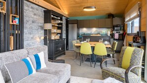 A cozy interior with a dining area, kitchen, and seating.