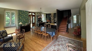 A spacious living room with a dining area, a staircase, and a kitchen. - Family home in green setting near village, municipal swimming pool, nogaro (Panjas)