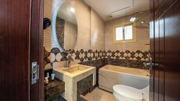 A bathroom with a bathtub, a sink, and a toilet.