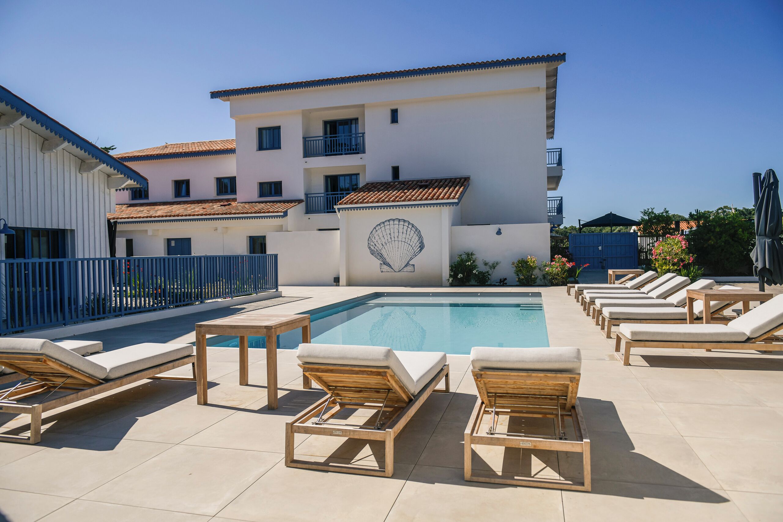 A poolside area with lounge chairs and a swimming pool.