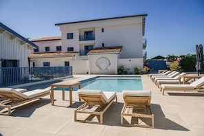 Seasonal outdoor pool, open 10:00 AM to 8:00 PM, pool umbrellas