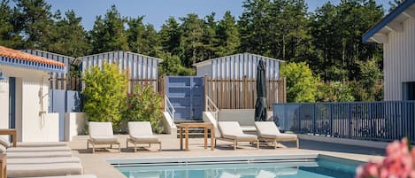 Seasonal outdoor pool, open 10:00 AM to 8:00 PM, pool umbrellas