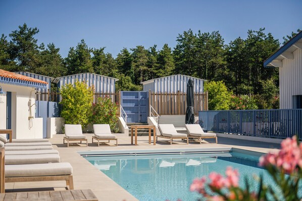 Seasonal outdoor pool, open 10:00 AM to 8:00 PM, pool umbrellas