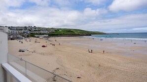 A beach with a view of a town in the background.