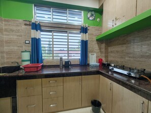 Fridge, stovetop, electric kettle, cookware/dishes/utensils