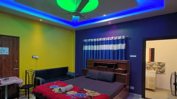 A modern bedroom with a bed, a desk, and a chair.