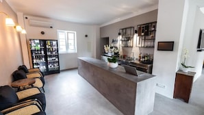 A modern kitchen with a central island, bar area, and seating arrangement. - Hiša OPERA (Maribor)