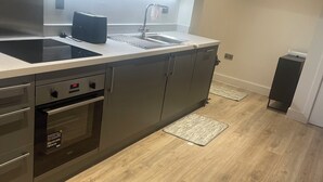 A modern kitchen with a built-in oven, a sink, and a countertop.