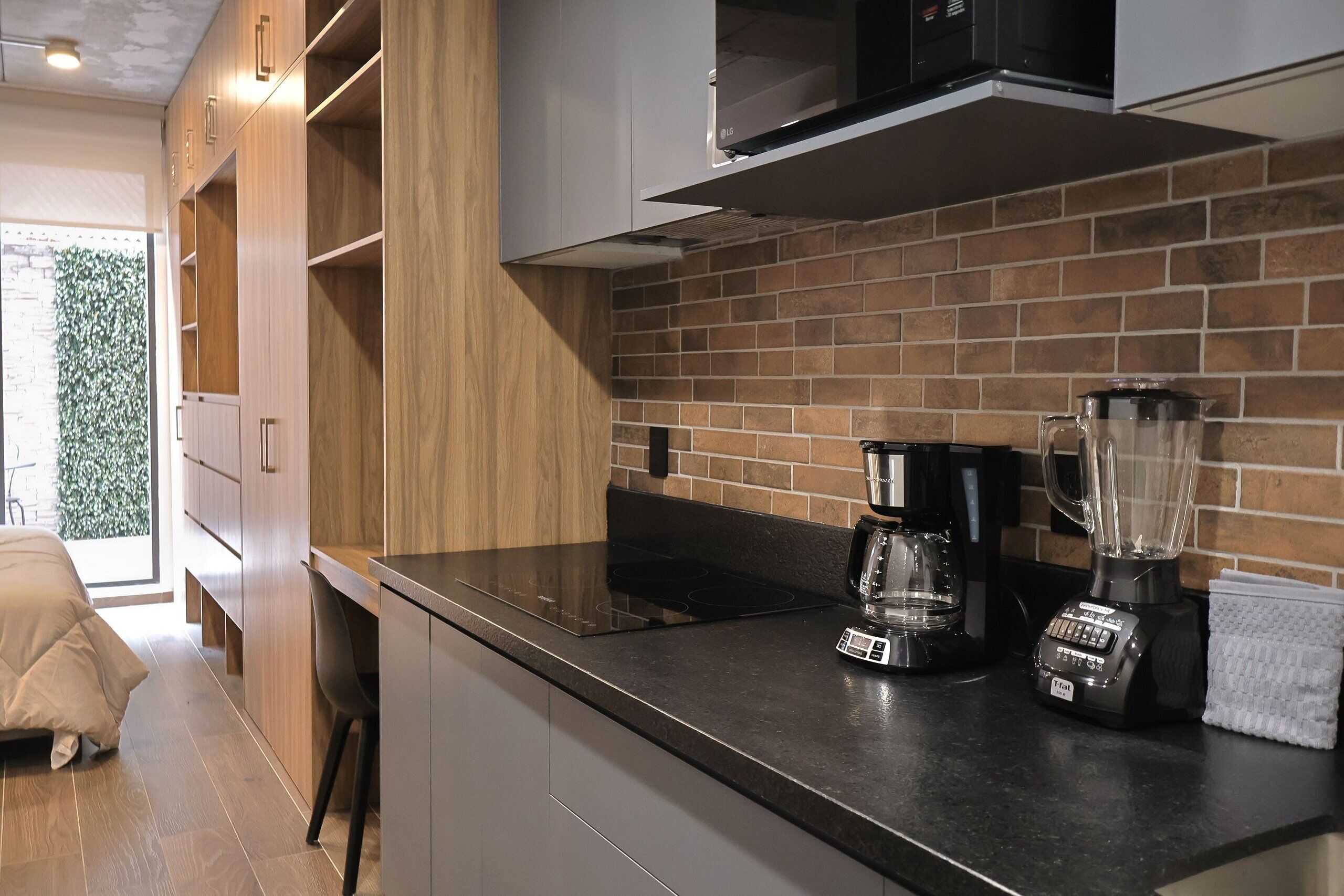 Fridge, microwave, coffee/tea maker, cookware/dishes/utensils