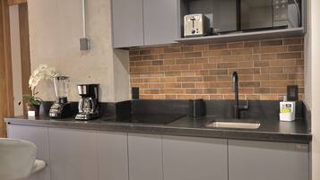 Fridge, microwave, coffee/tea maker, cookware/dishes/utensils