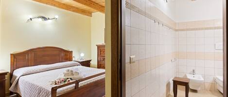 A bedroom with a wooden bed, bedside tables, and a nightstand.